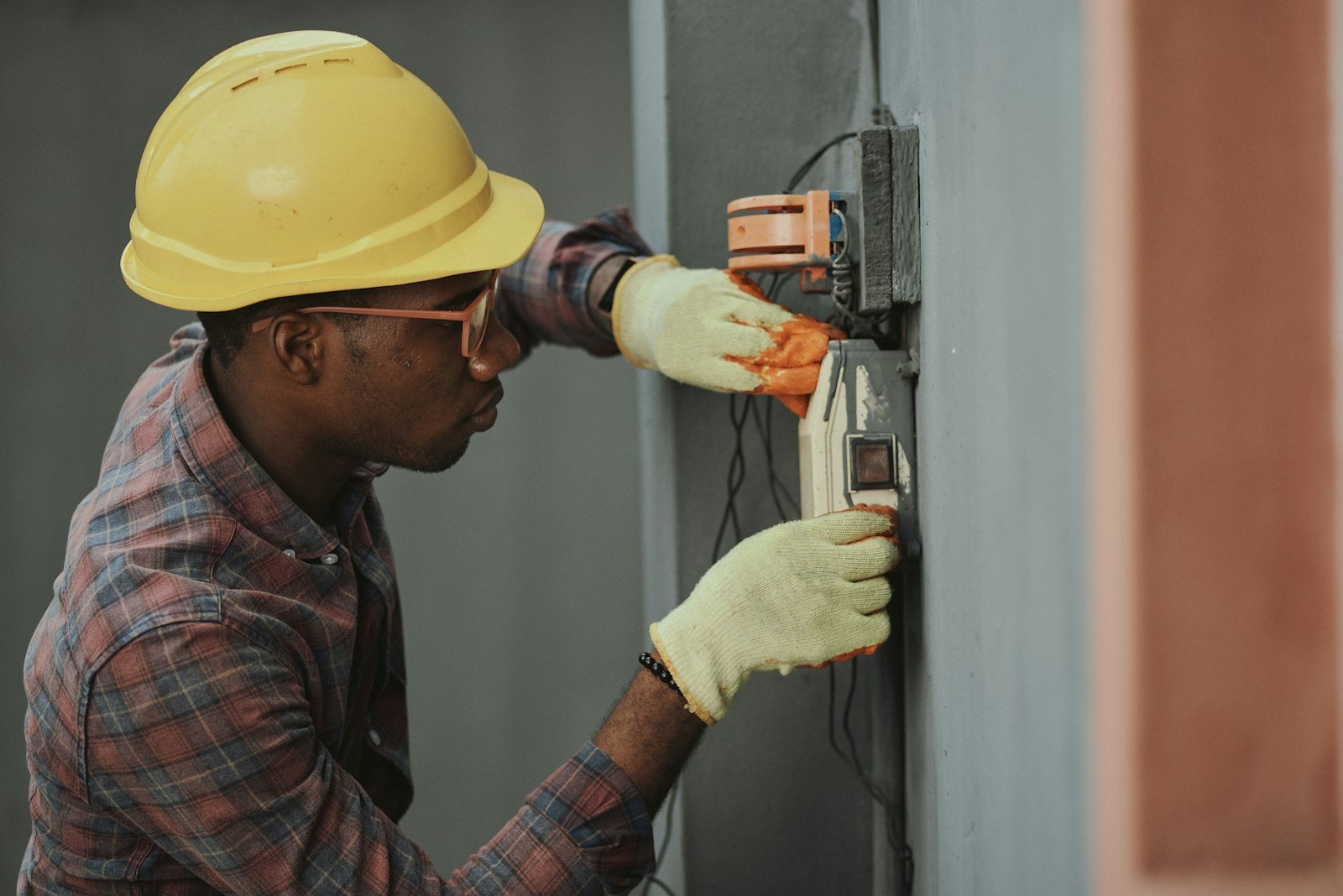 Licensed electrician at work on exterior electrical equipment