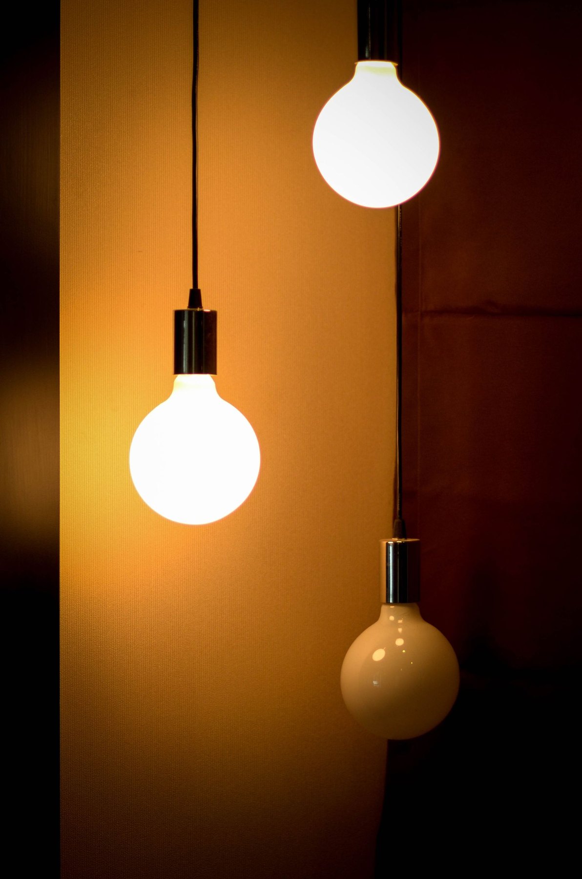 Pendant lighting fixtures, some on and one off