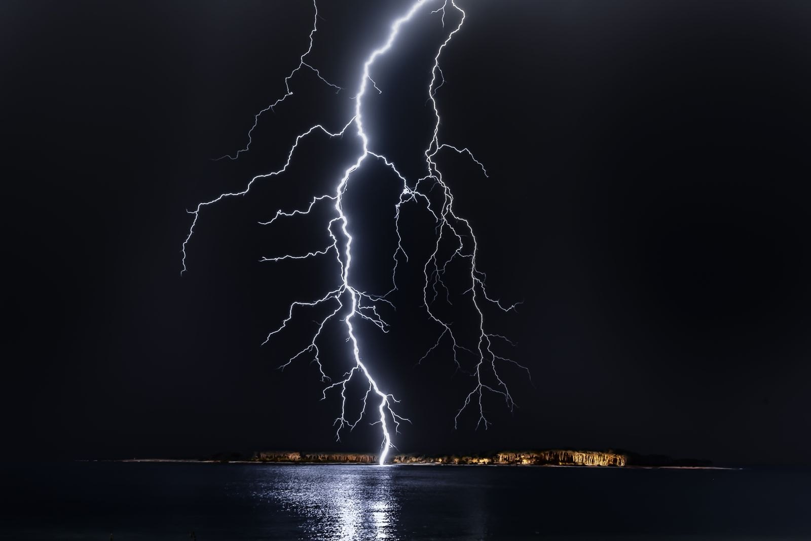 Lightning over water — Tallahassee storm season is why surge protection matters